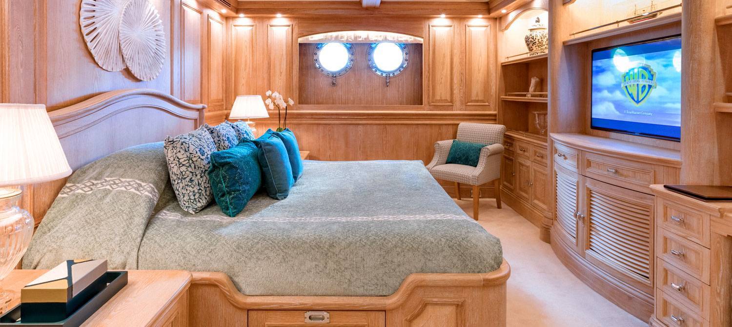 Bed facing a TV in one of the double cabins on NERO Yacht.