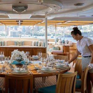 NERO Yacht stewardesses set the table for dining.