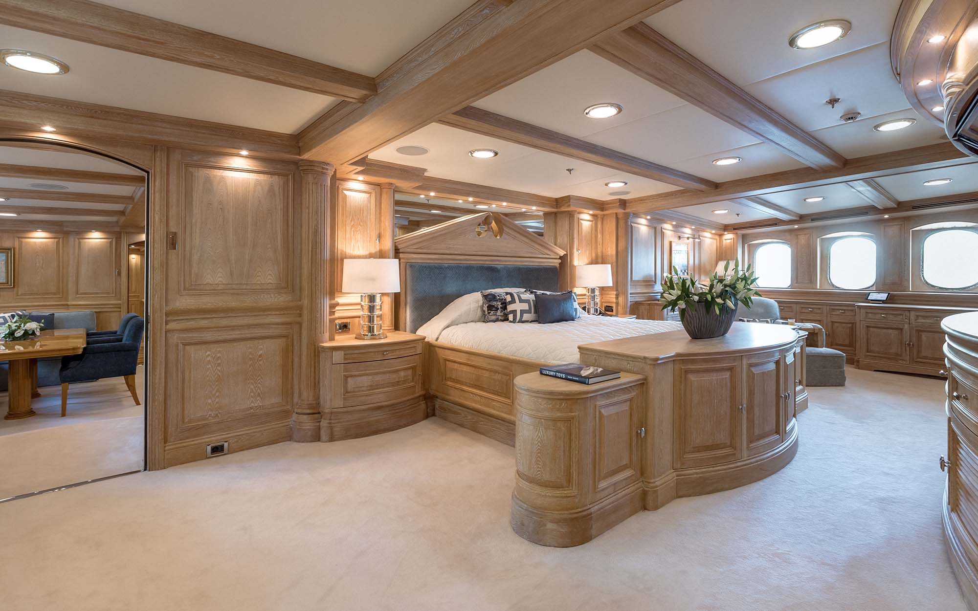 NERO Yacht master suite with light wood paneling